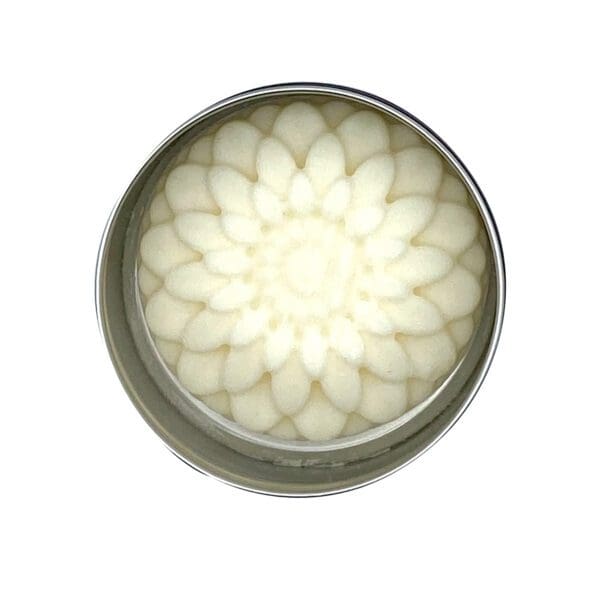 Top view of a round silver tin containing Hike Your Own Hike Lotion Bar with a floral pattern.