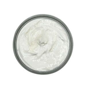 The Loving Lavender Body Butter, seen from above, is a round container filled with a white creamy substance.