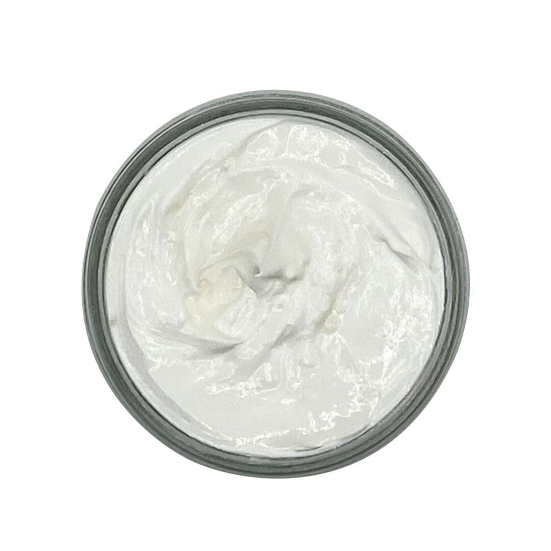 The Loving Lavender Body Butter, seen from above, is a round container filled with a white creamy substance.