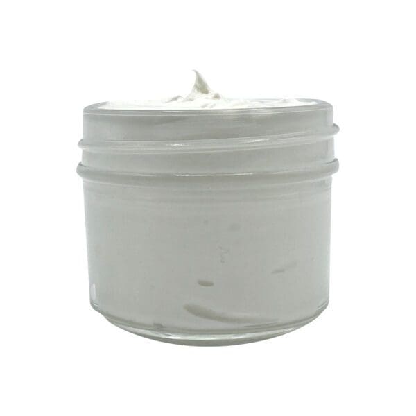 A 4oz glass jar of Loving Lavender Body Butter, topped with a slightly peaked white cream, set against a plain white background.