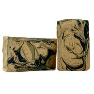 Two Rise & Shine rectangular handmade soap bars, featuring swirling black and beige designs, are positioned upright and leaning against each other on a white background.
