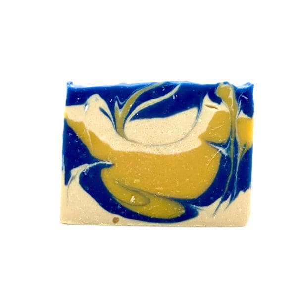 The Crisp Cotton soap features a rectangular shape with abstract blue, yellow, and beige swirling designs that resemble flowing patterns.