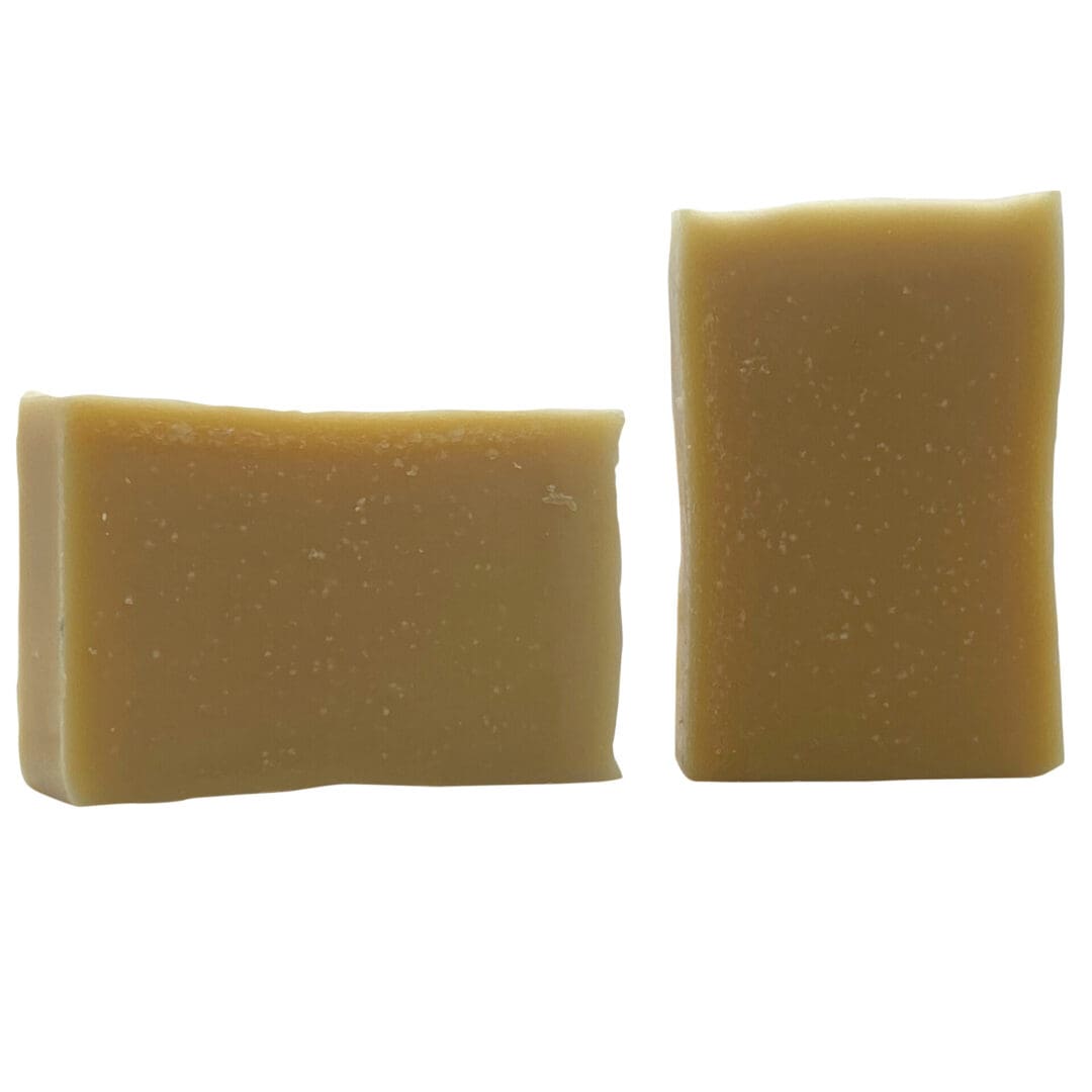 Two rectangular bars of Natural light brown soap on a plain white background.