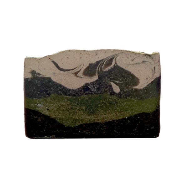 The "Hike Your Own Hike" soap is a rectangular bar with a layered design in black, green, and beige, showcasing swirling patterns on its surface.