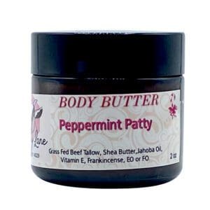 A 2oz black jar of Peppermint Patty Body Butter features grass-fed beef tallow, shea butter, and essential oils, with a white and pink label.