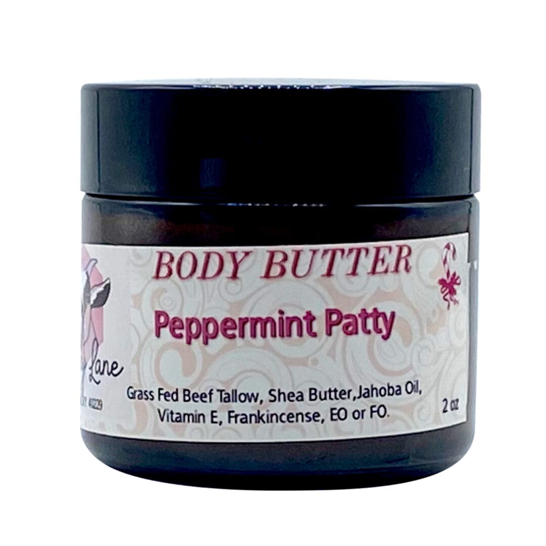 A 2oz black jar of Peppermint Patty Body Butter features grass-fed beef tallow, shea butter, and essential oils, with a white and pink label.