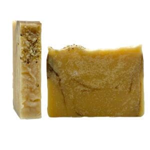 The image features two bars of Spring Rain handcrafted soap; one displayed from the side displays its textured surface, while the other shows a smooth yellow front with speckled areas on top.